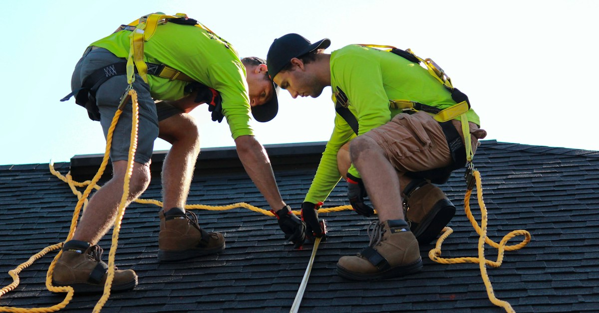 Solar rooftop technicians positioning panels at a suitable tilt angle